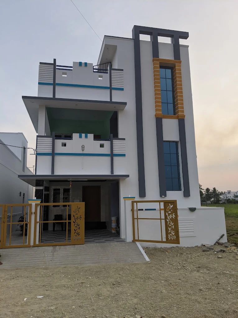 Modern white villa with grey pillars and gold gate