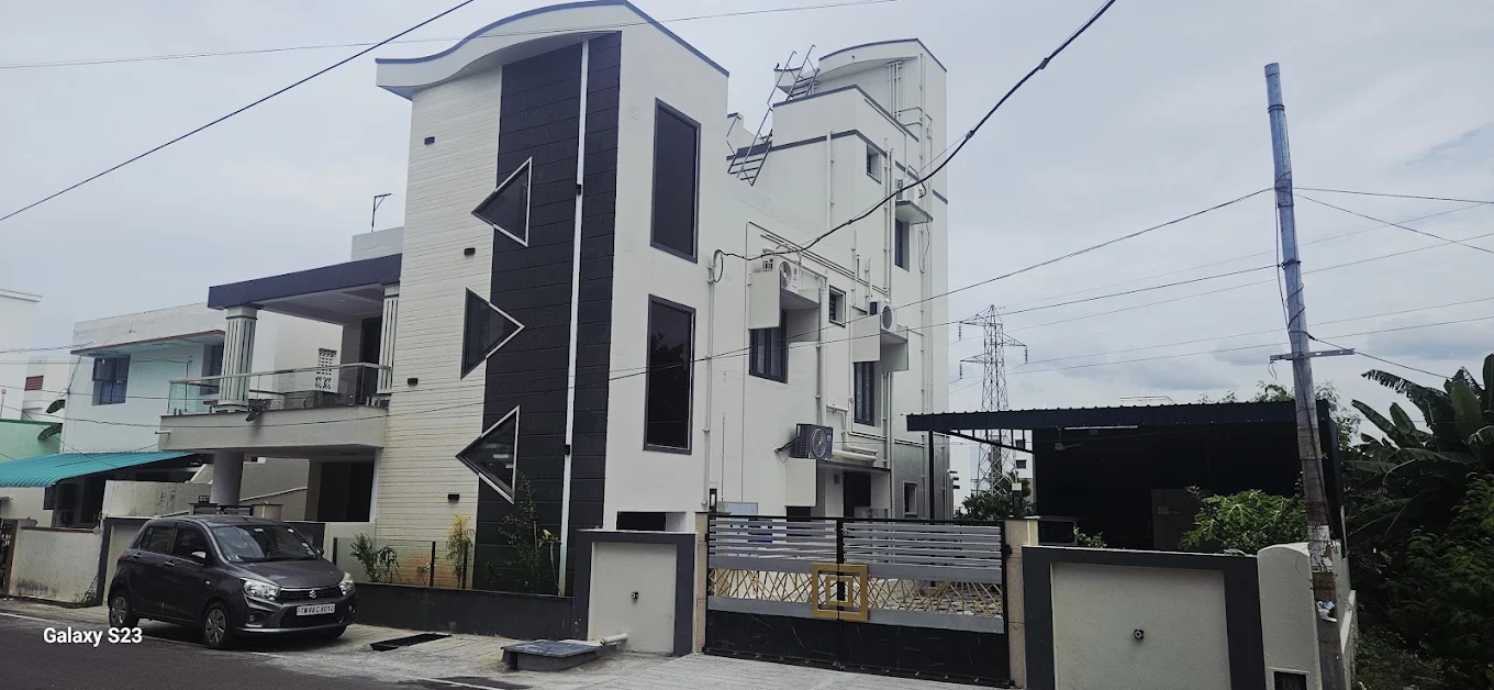 White and black contemporary duplex with compound wall
